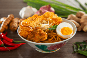 Golden Hour Food Photography: Fiery laksa glowing under warm natural light