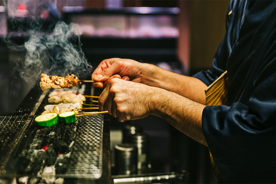 Food Photography in SG : Hawker preparing skewers over a charcoal grill
