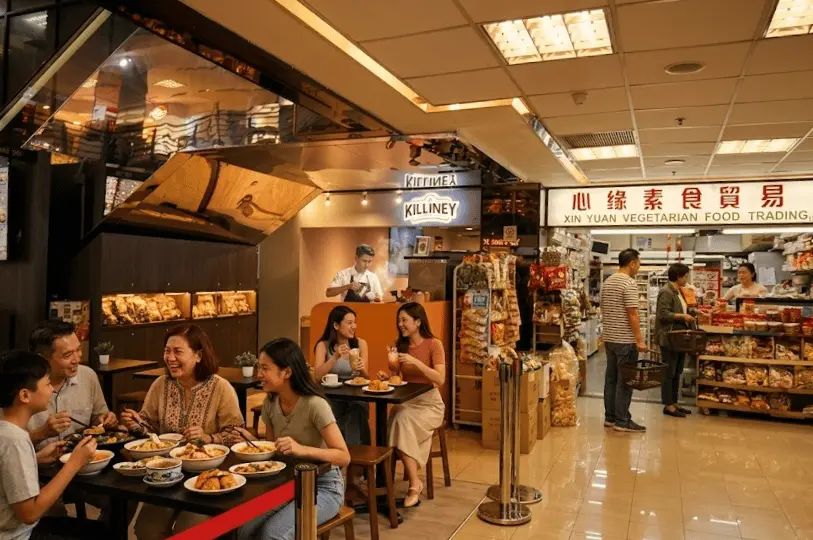 A bustling dining hall scene capturing a large shared table completely filled with diverse, freshly prepared meals, highlighting the vibrant communal lunch hour atmosphere.